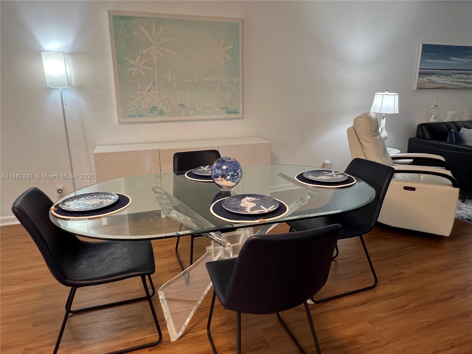 1280 Surf Road, Unit 103 Singer Island, FL 33404 - Photo 8 of 55 a view of a dining room with furniture and wooden floor