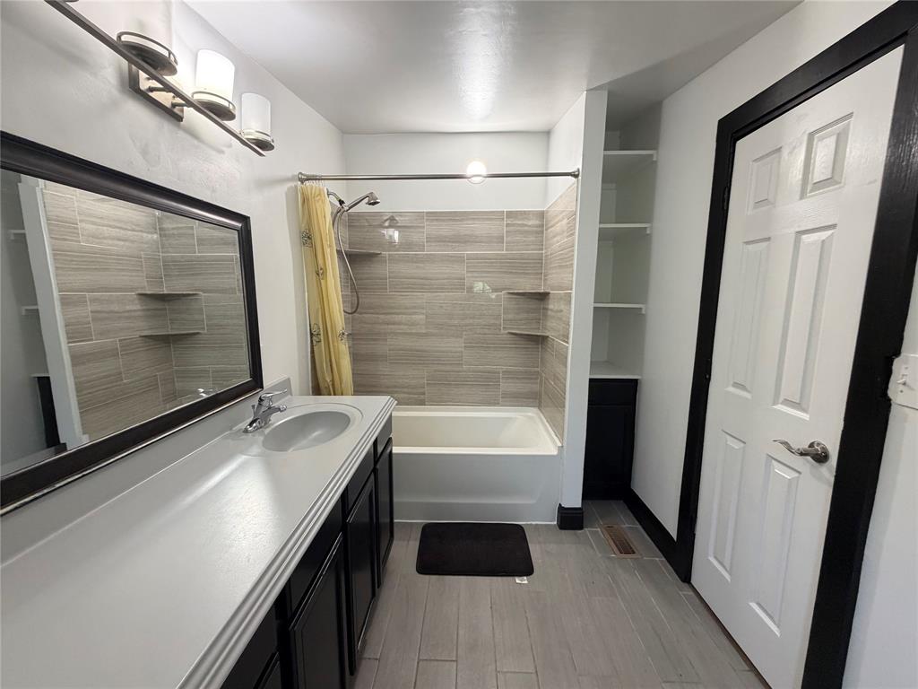 222 Hix Road Cleburne, TX 76031 - Photo 11 of 27 a bathroom with a tub sink and a mirror
