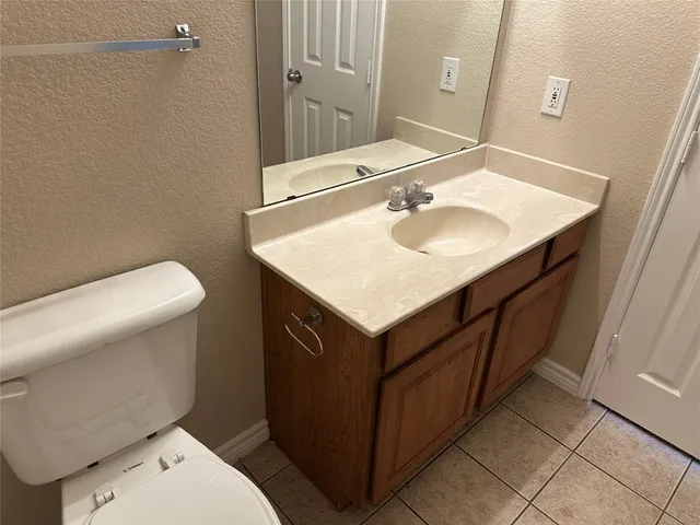 a white toilet and tub next to a white cabinet