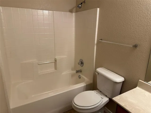 an empty room with closet and a bathroom