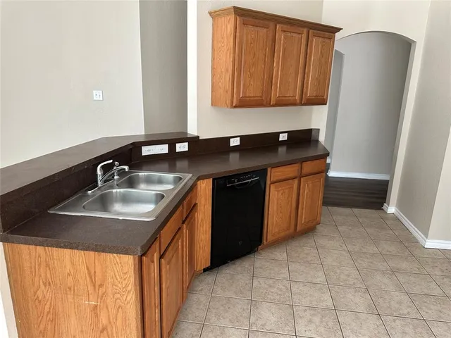 a kitchen with stainless steel appliances granite countertop a sink and a refrigerator