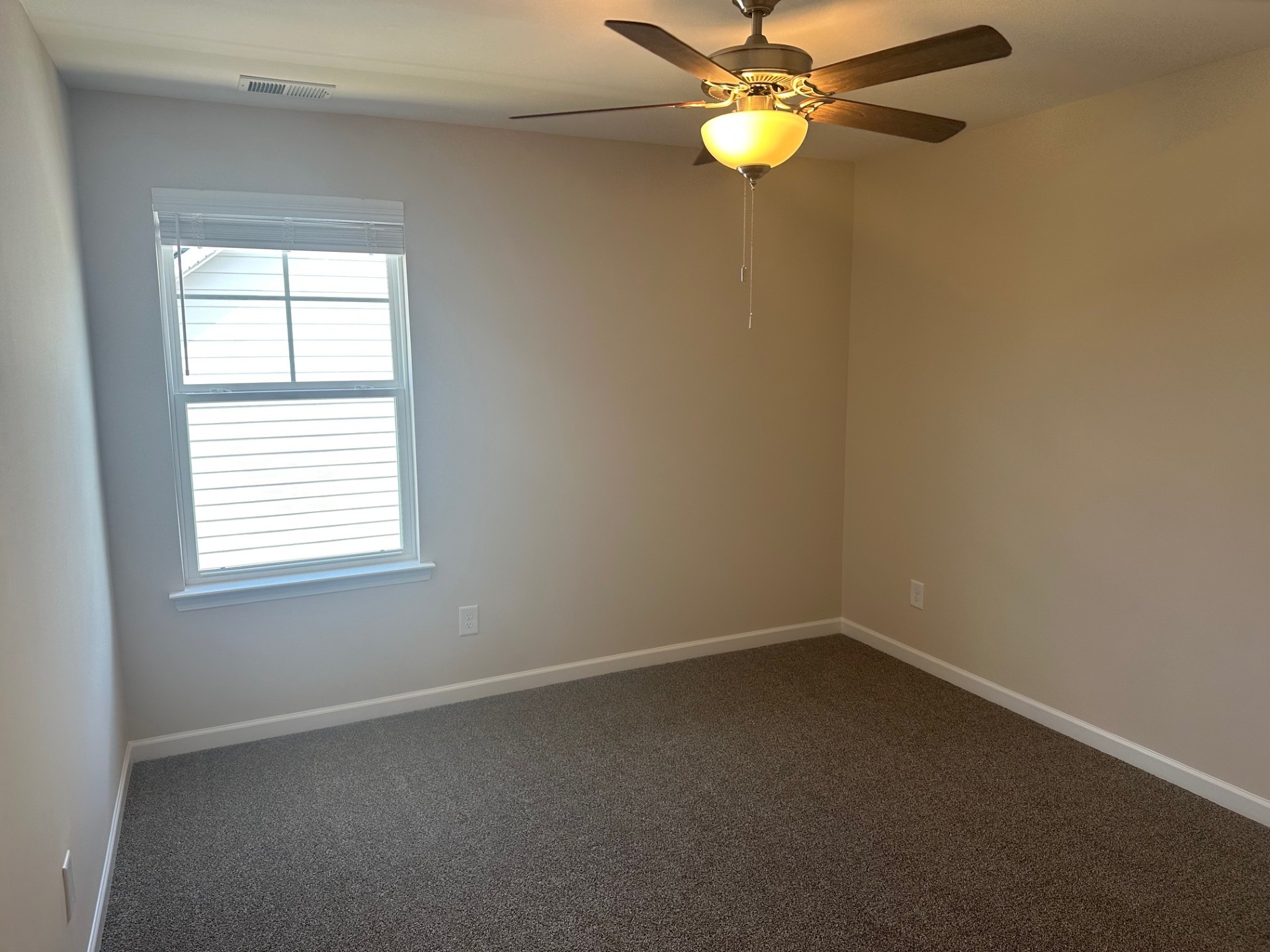 7017 Sully Court Fairview, TN 37062 - Photo 12 of 16 an empty room with windows and fan