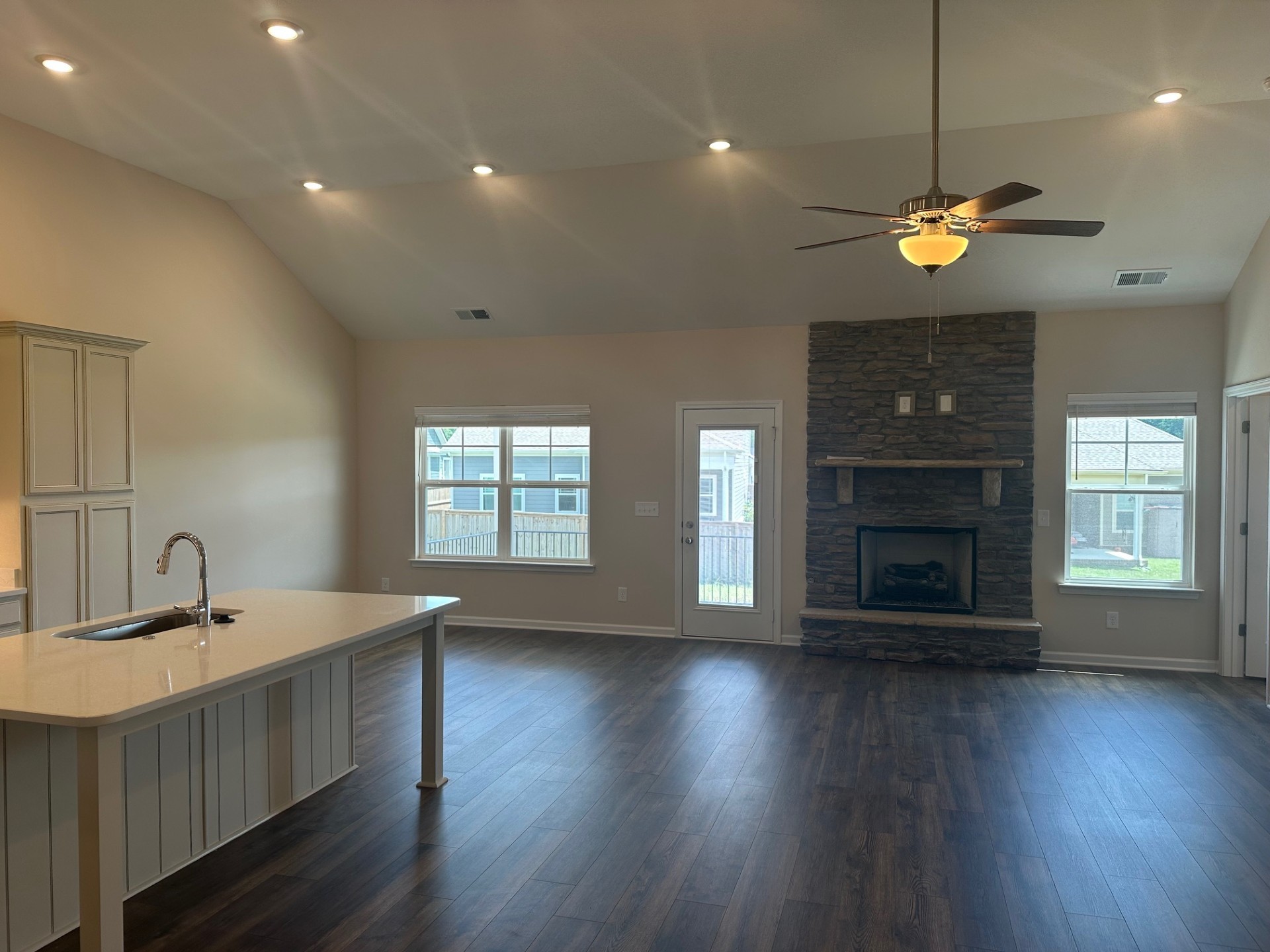 7017 Sully Court Fairview, TN 37062 - Photo 3 of 16 a view of a kitchen with a sink a fireplace and wooden floor