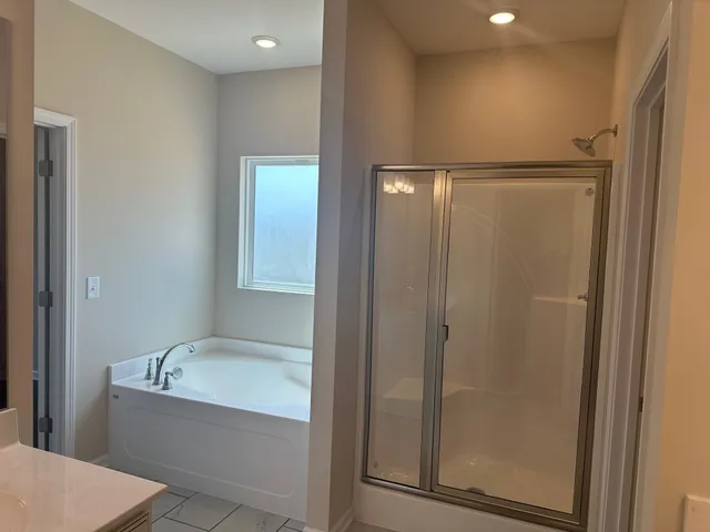 a bathroom with a bathtub and a shower