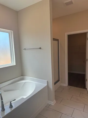 a bathroom with a bathtub and a shower