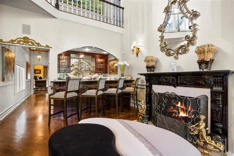 a living room with chairs and a fireplace
