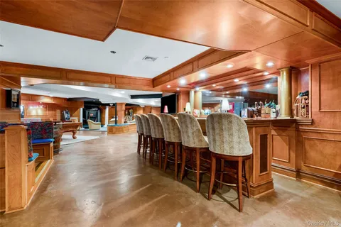 a dining area with stainless steel appliances lots of wooden furniture