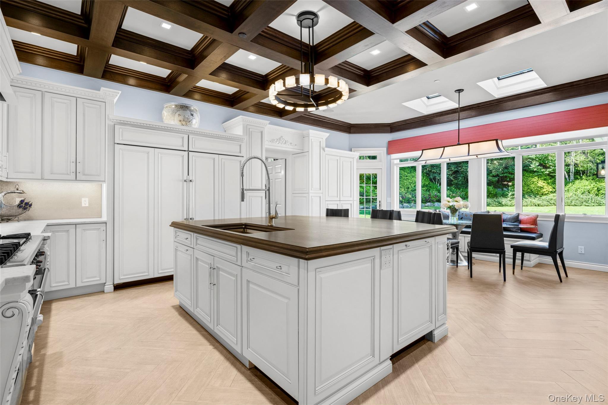 23 Pheasant Drive Rye, NY 10580 - Photo 8 of 35 Idyllic kitchen dining area with custom window seat overlooks the gorgeous back garden. Dine with the sound of the fountain streaming in from the french doors to the outdoor kitchen.