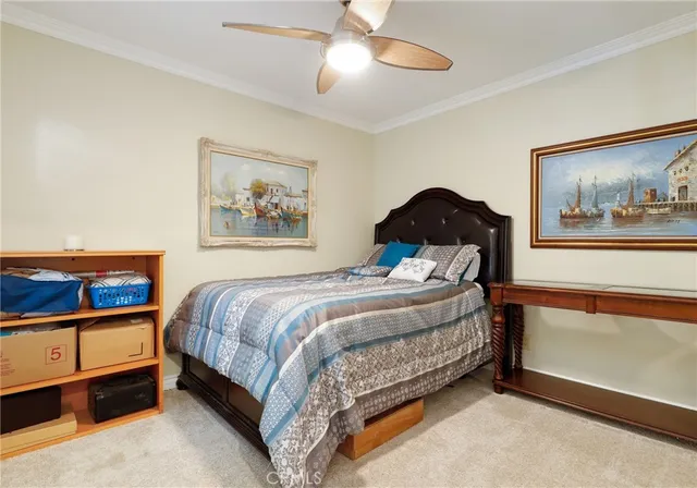 a bedroom with a bed and a painting on the wall