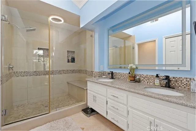 a bathroom with a granite countertop sink mirror and double