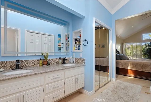 a en suite bathroom with double sink and a mirror
