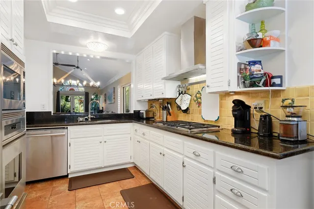 a kitchen with granite countertop white cabinets and white appliances
