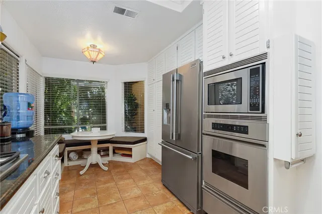 a kitchen with stainless steel appliances granite countertop a stove and a refrigerator
