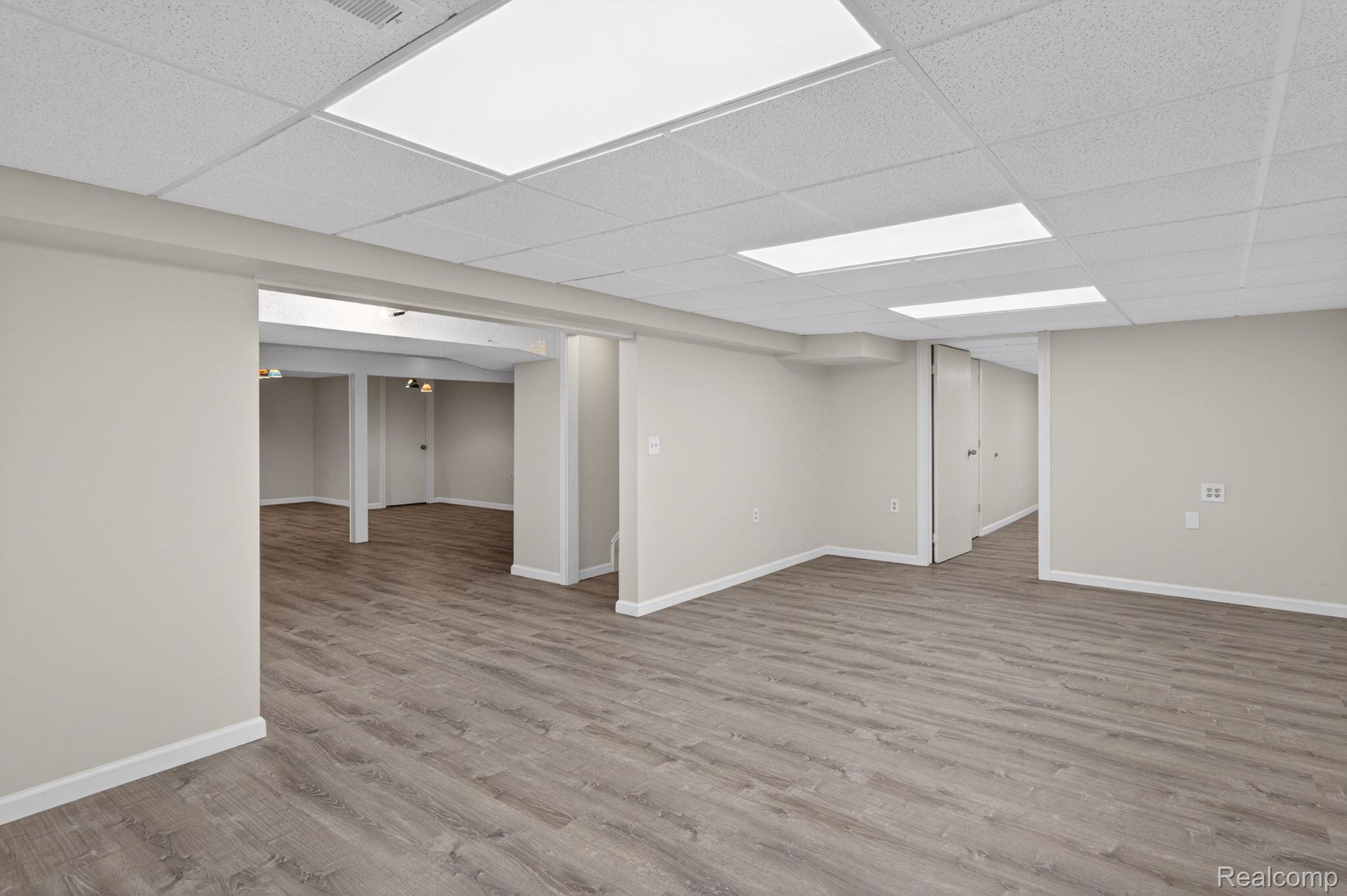 9353 Hill Road Swartz Creek, MI 48473 - Photo 63 of 98 Spacious room featuring wood-finish flooring, neutral paint, recessed lighting, and a drop ceiling