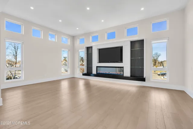 an empty room with window and wooden floor