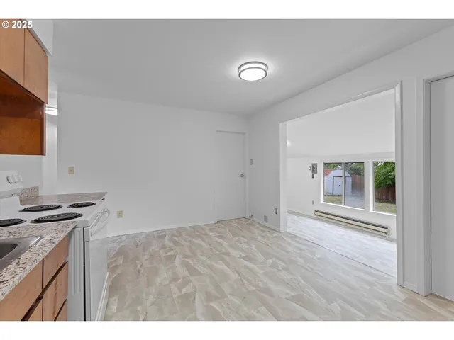 a view of kitchen with granite countertop cabinets appliances and a sink