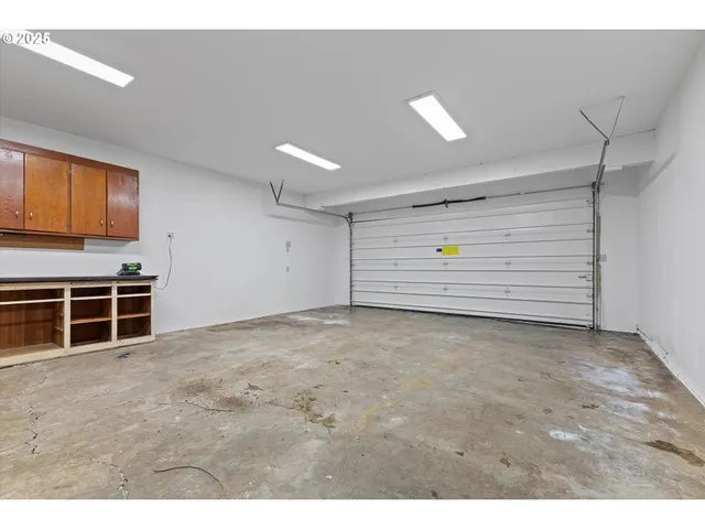 a view of an empty room with furniture and garage