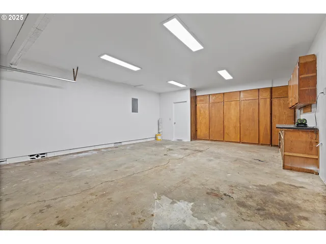 a view of an empty room with a cabinet