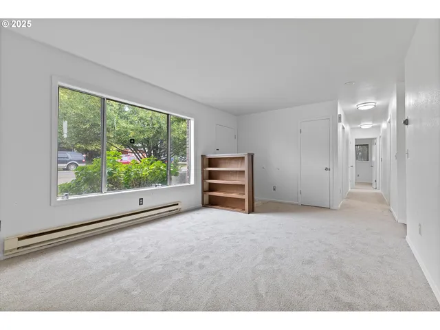 a view of empty room with floor to ceiling window