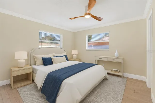 a bedroom with bed and a chandelier