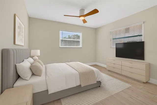 a bedroom with a bed and a flat screen tv