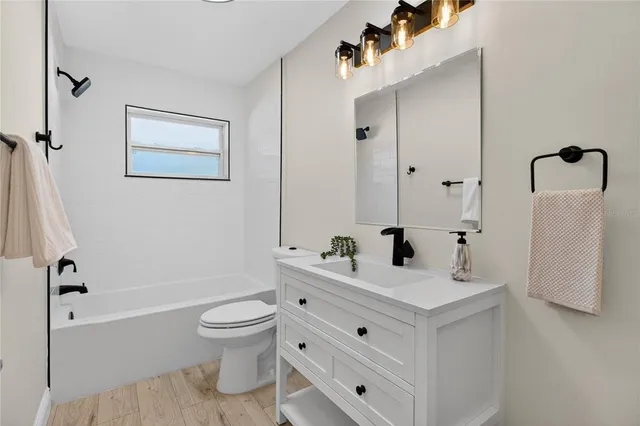 a bathroom with a double vanity sink toilet and shower