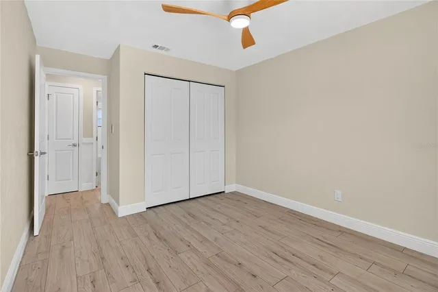 a view of an empty room with wooden floor