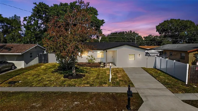 a view of house with backyard