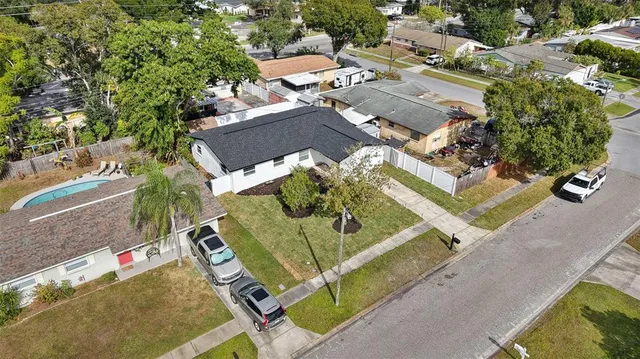 an aerial view of a residential houses with yard