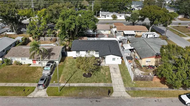 an aerial view of a residential apartment building with a yard