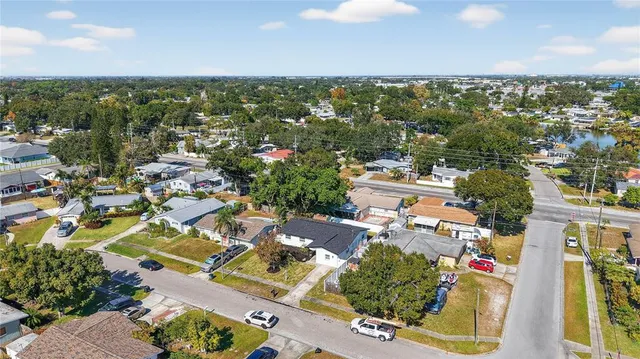 an aerial view of residential houses with outdoor space