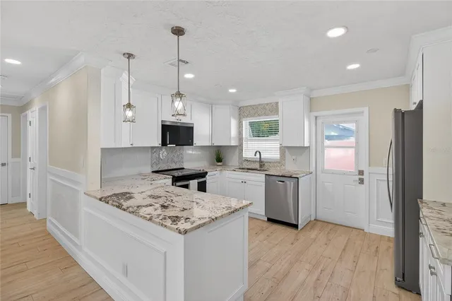 a kitchen with a sink stove and refrigerator