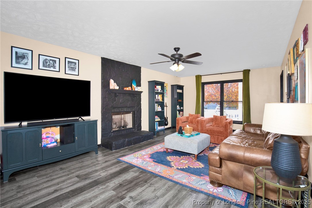529 Old Farm Road Fayetteville, NC 28314 - Photo 11 of 35 a living room with furniture a flat screen tv and a fireplace