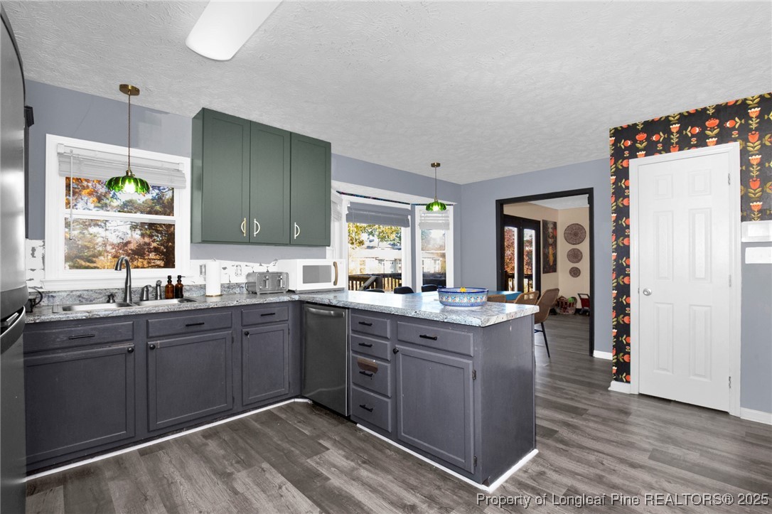 529 Old Farm Road Fayetteville, NC 28314 - Photo 15 of 35 a kitchen with sink cabinets and wooden floor