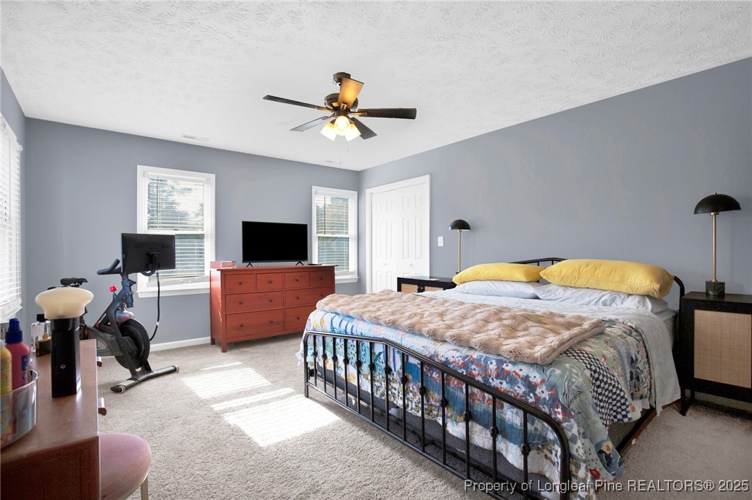 529 Old Farm Road Fayetteville, NC 28314 - Photo 19 of 35 a bedroom with a bed a couch and a flat screen tv