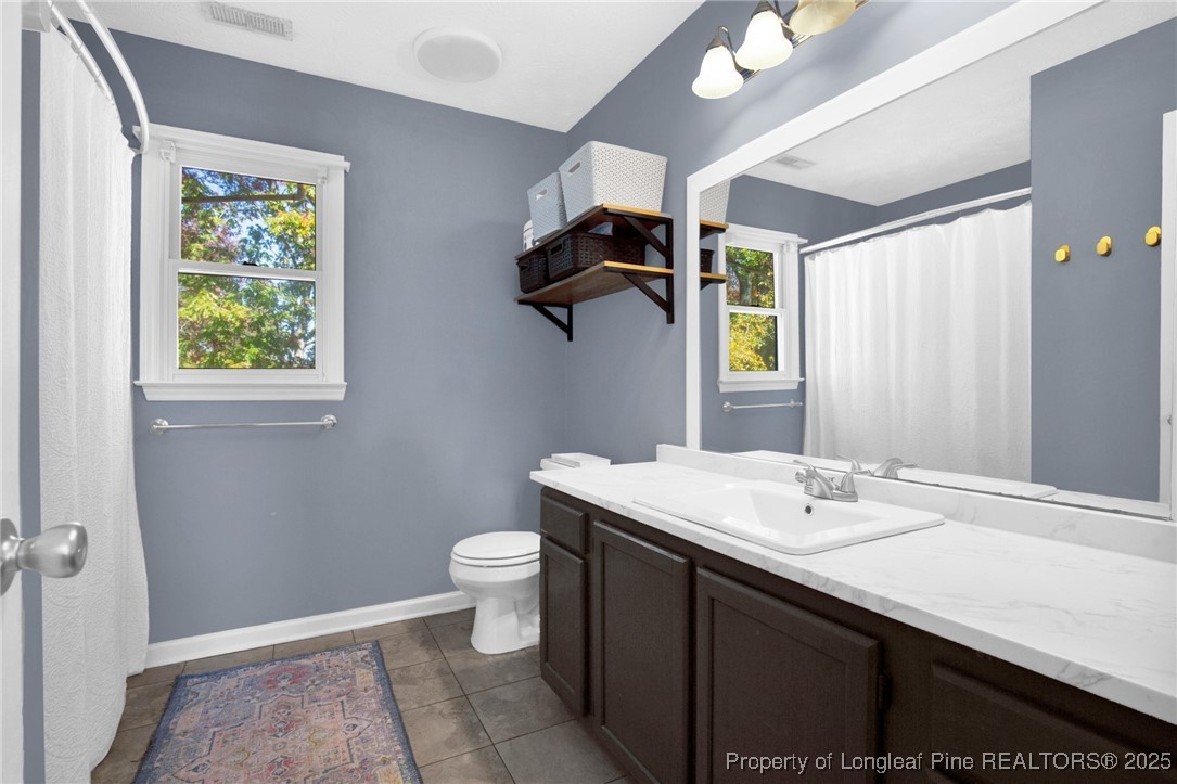 529 Old Farm Road Fayetteville, NC 28314 - Photo 21 of 35 a bathroom with a sink a toilet and a mirror