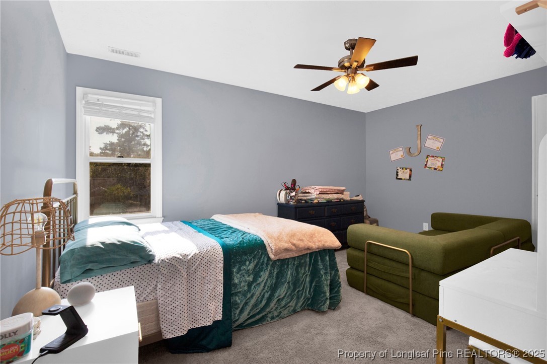 529 Old Farm Road Fayetteville, NC 28314 - Photo 22 of 35 a bedroom with bed and a chandelier