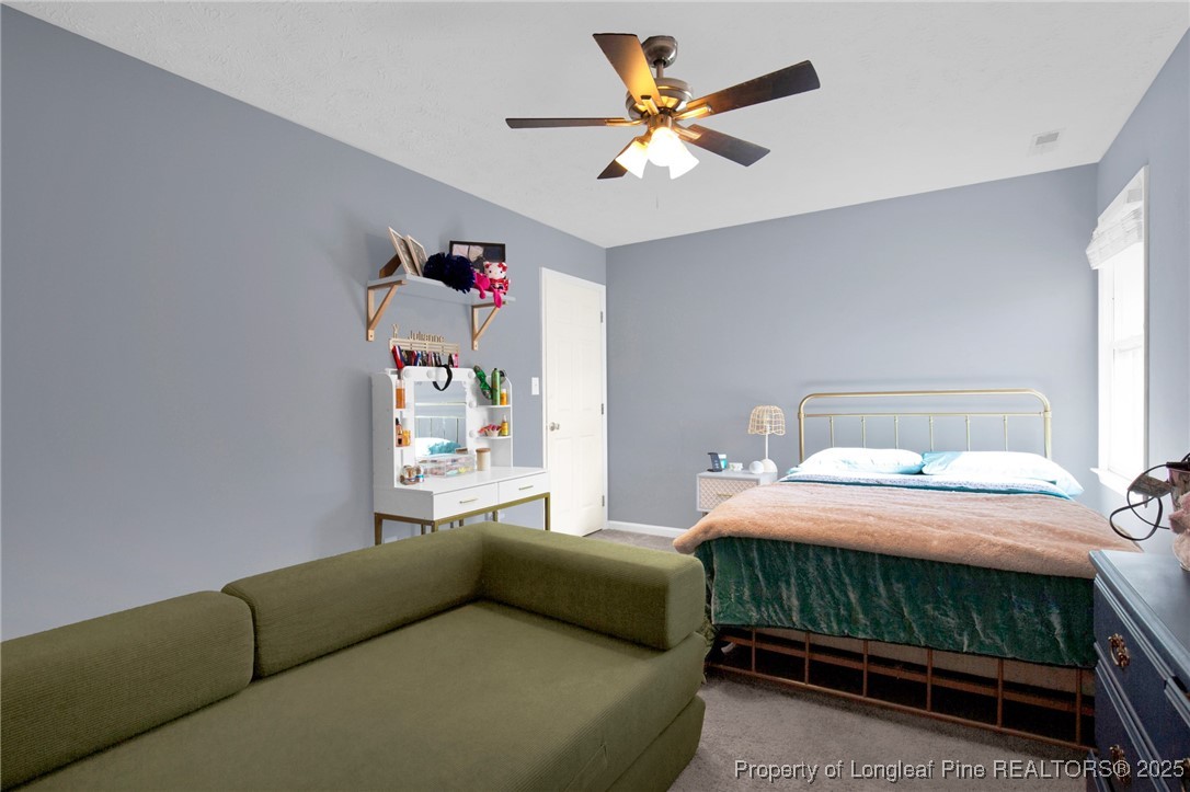 529 Old Farm Road Fayetteville, NC 28314 - Photo 23 of 35 a bedroom with a bed and a chandelier