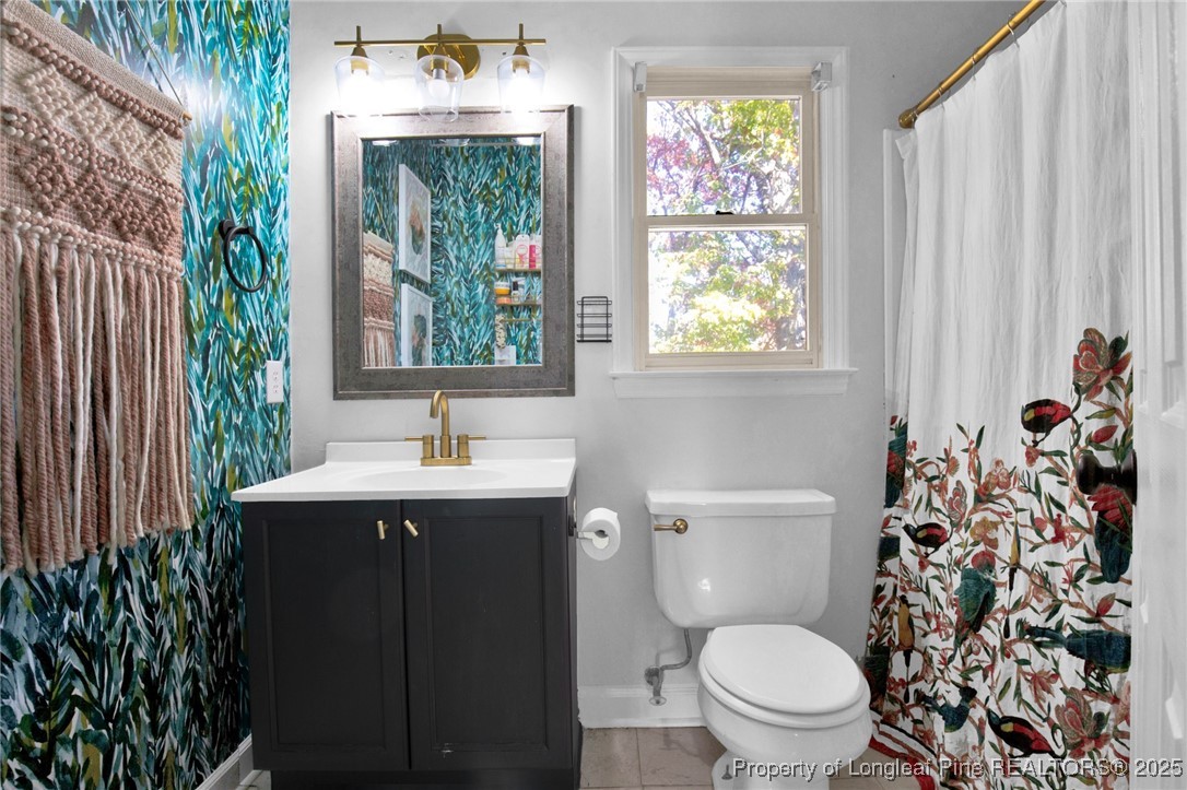 529 Old Farm Road Fayetteville, NC 28314 - Photo 26 of 35 a bathroom with a toilet sink and mirror
