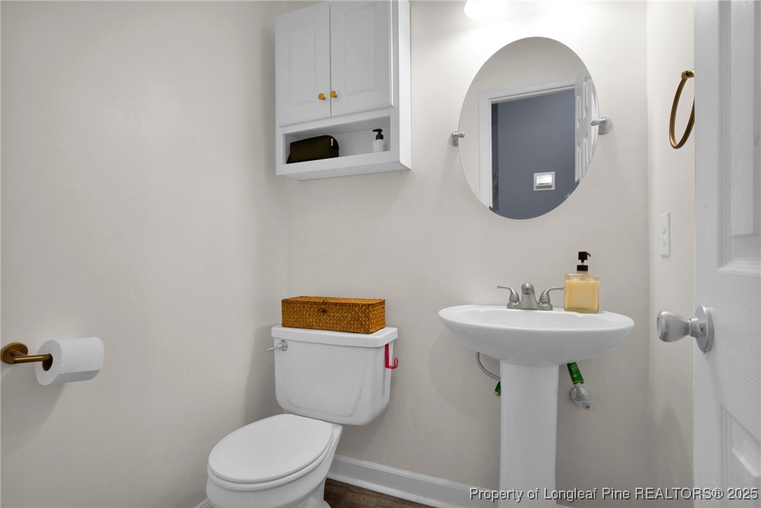 529 Old Farm Road Fayetteville, NC 28314 - Photo 27 of 35 a bathroom with a toilet sink and mirror