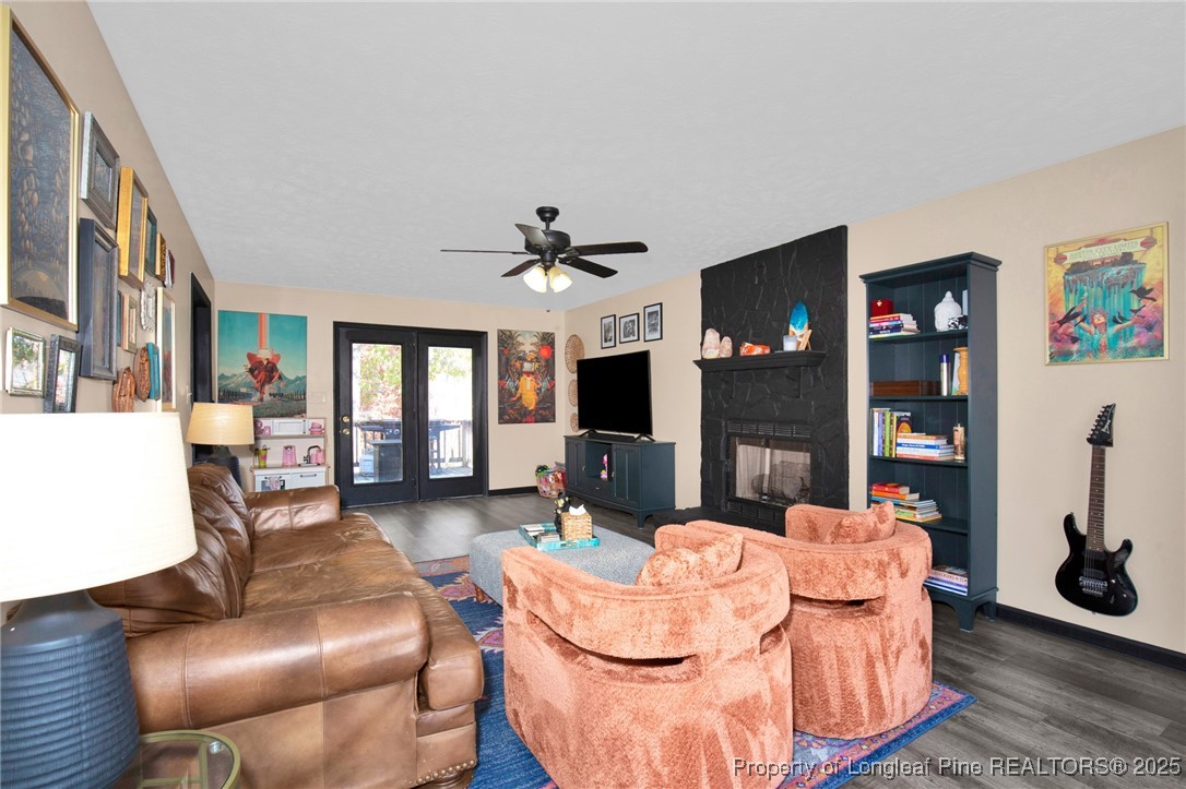 529 Old Farm Road Fayetteville, NC 28314 - Photo 9 of 35 a living room with furniture a flat screen tv and a fireplace