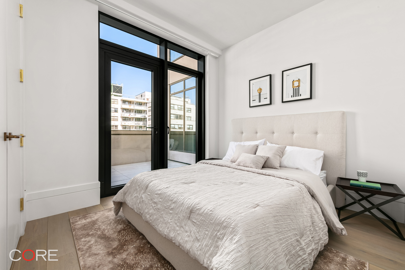 310 East 86th Street, Unit 19C Manhattan, NY 10028 - Photo 10 of 20 a large bed sitting in a bedroom next to a window