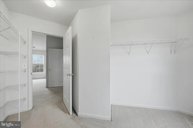 an empty room with a ceiling fan and window