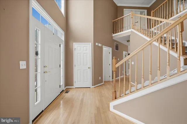a view of entryway with wooden floor and stairs