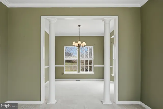 a view of a room with large windows and cabinet