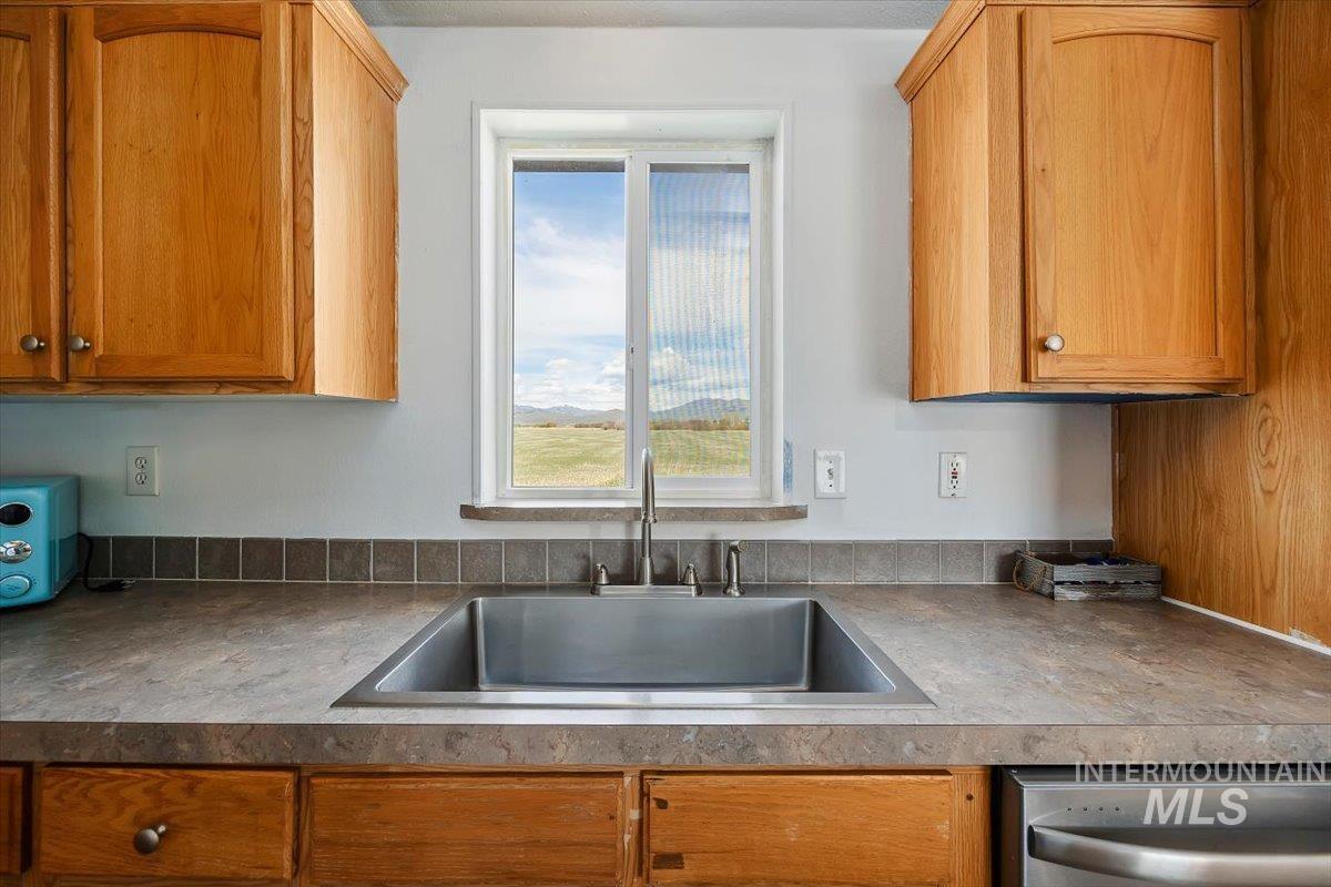 501 Timber Avenue Fairfield, ID 83327 - Photo 11 of 27 Kitchen with wood finish cabinets and dishwasher