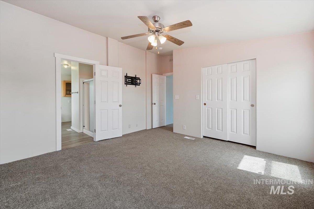 501 Timber Avenue Fairfield, ID 83327 - Photo 14 of 27 Unfurnished bedroom with carpet, a closet, and ceiling fan