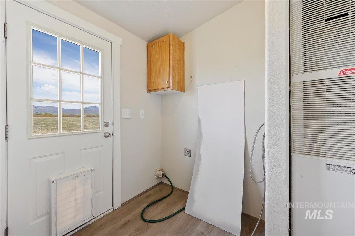 501 Timber Avenue Fairfield, ID 83327 - Photo 21 of 27 Laundry room featuring a heating unit and light wood-style floors
