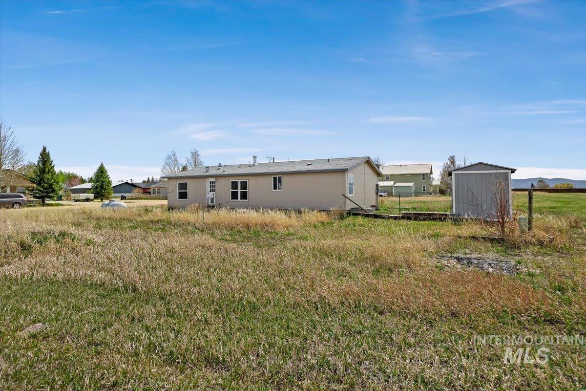 501 Timber Avenue Fairfield, ID 83327 - Photo 23 of 27 Rear view of house featuring a storage unit