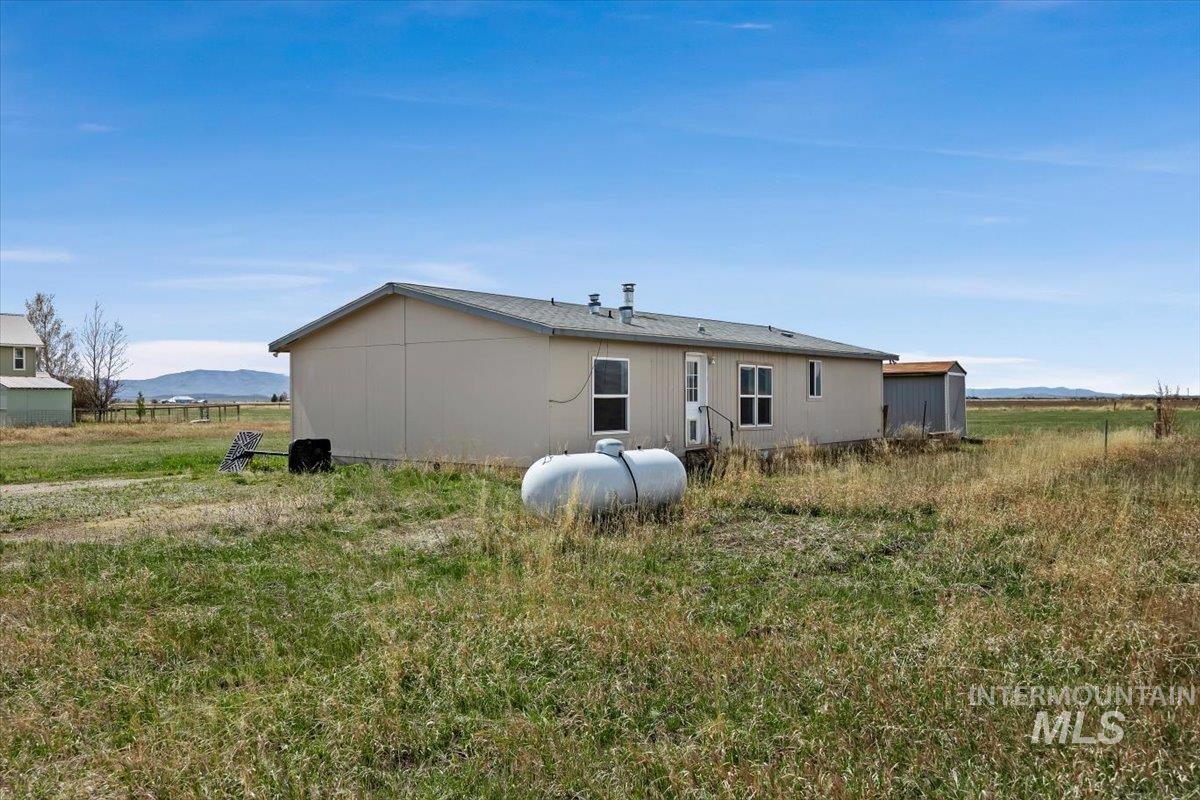 501 Timber Avenue Fairfield, ID 83327 - Photo 3 of 27 Rear view of property with a view of countryside and a mountain view